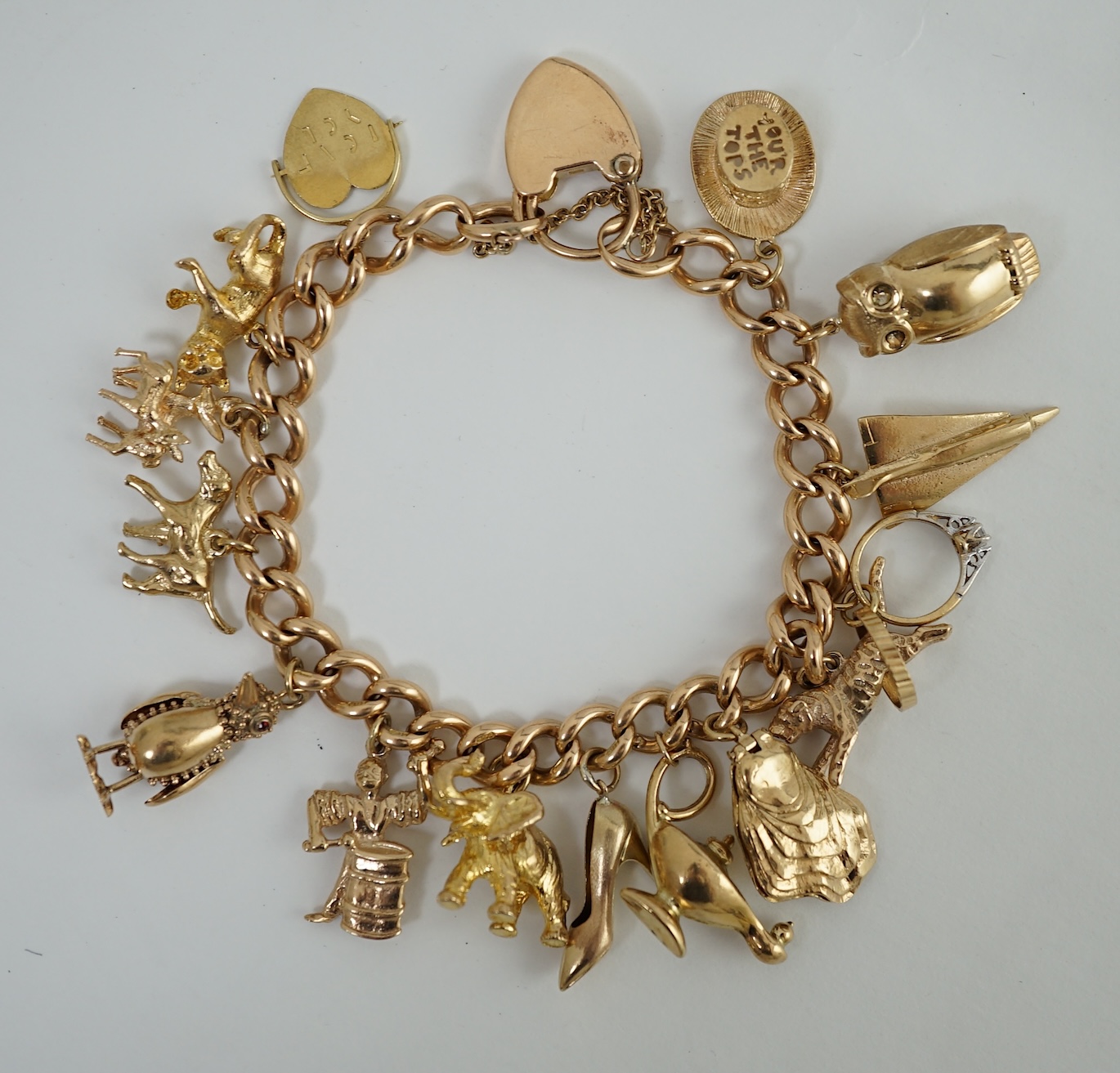 An early 20th century 15ct gold curb link charm bracelet